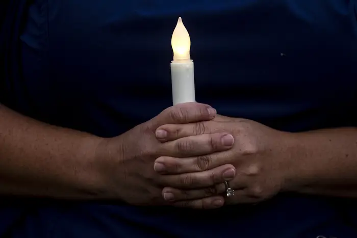 A nurse holds a candle at a vigil in Los Angeles, California on May 6th.